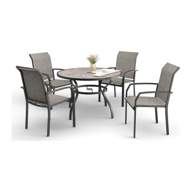 Round dining table with four gray sling chairs